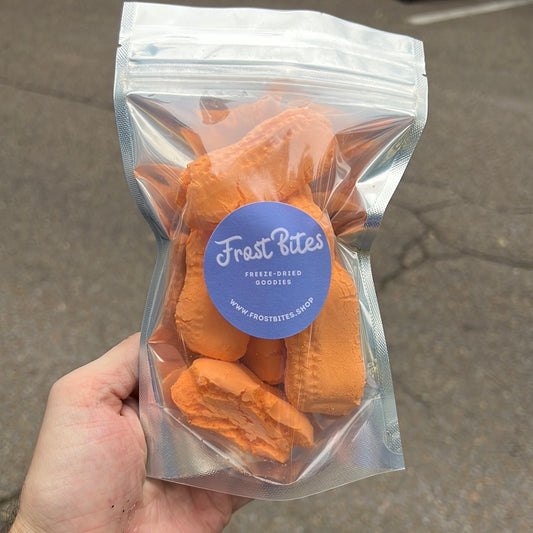 A person holding a bag of Frost Bites Circus Peanuts.